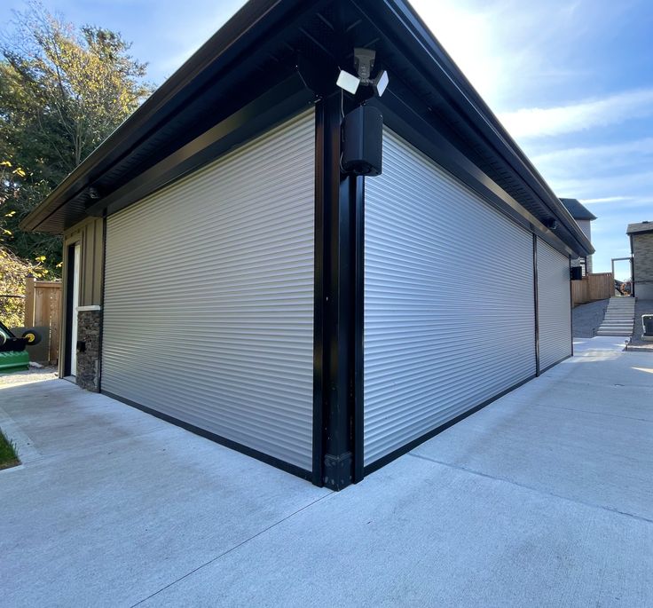 Security roller shutters for shop windows White security roller shutters on the windows of a commercial building