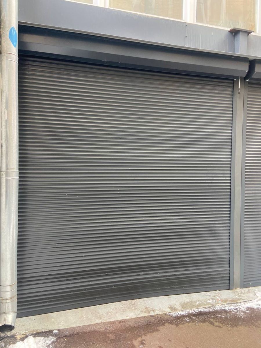 Damaged security shutters before repair Kharkiv